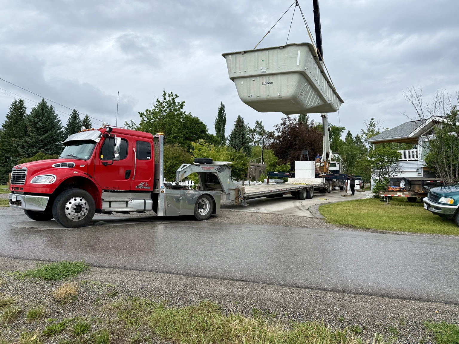 Crane lifting large pool with All In Express truck