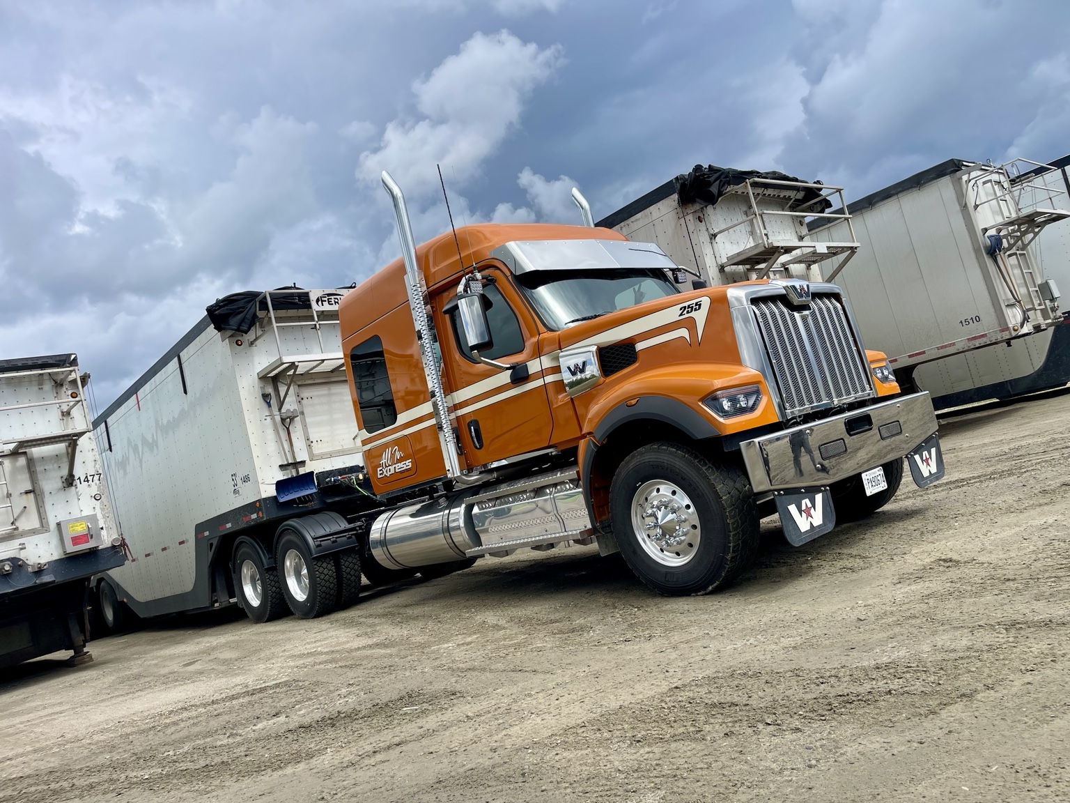 Orange truck with dump trailers